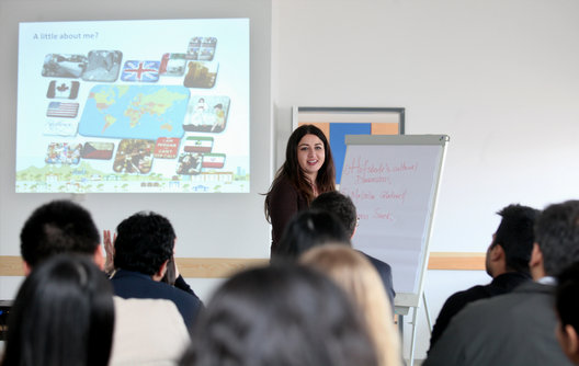 A presenter leading a study-trip session on international business