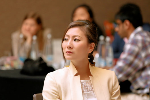A participant listening during a business study-trip session