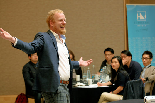 A speaker leading a discussion with students